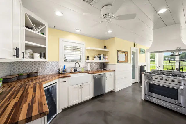 a kitchen with stainless steel appliances a stove sink and cabinets