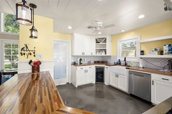 a kitchen with stainless steel appliances a stove sink and cabinets