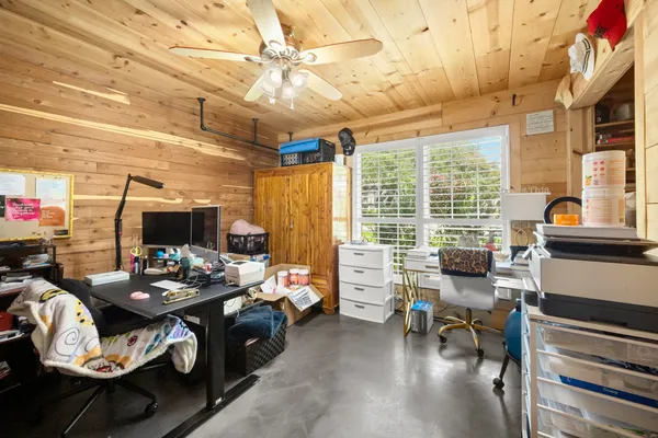 a bedroom with furniture and a wooden floor