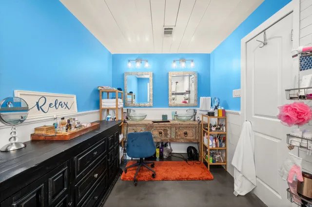 an empty room with wooden floor ceiling fan and windows