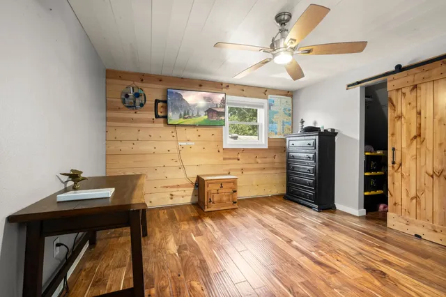 a bathroom with a granite countertop sink mirror vanity and toilet