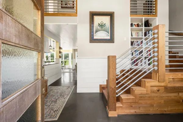 a view of entryway and hall with wooden floor