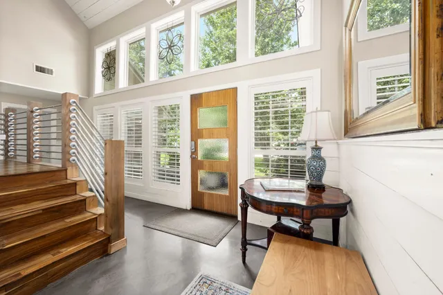 a living room with furniture wooden floor and a large window