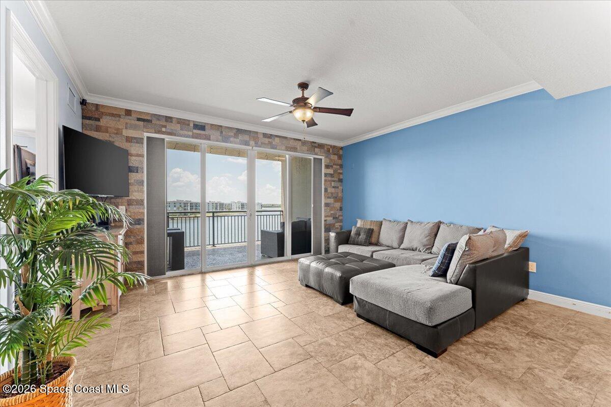 4125 West End Road, Unit 405 Cocoa Beach, FL 32931 - Photo 10 of 44 a living room with furniture and a flat screen tv
