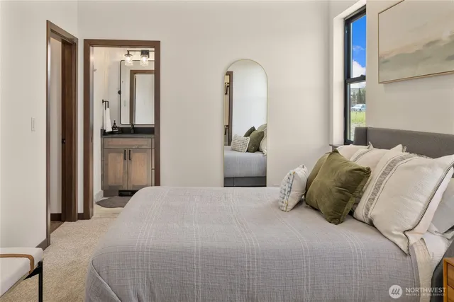 a bedroom with a bed and a mirror