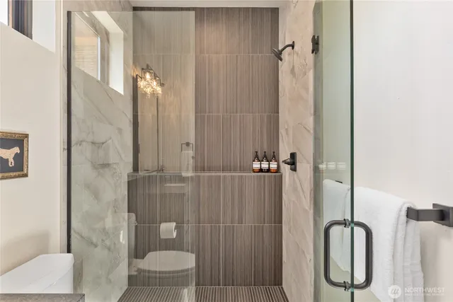 a bathroom with a granite countertop bathtub shower sink and toilet