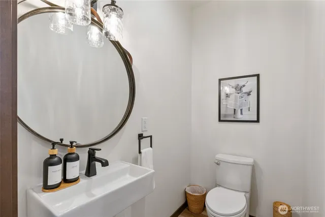 a bathroom with a toilet sink and mirror