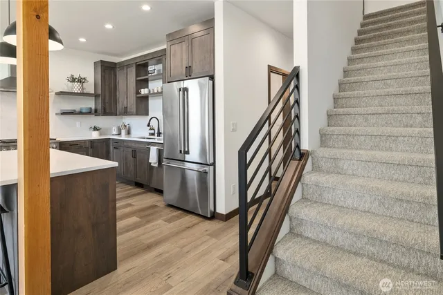a kitchen with stainless steel appliances a refrigerator and a stove top oven