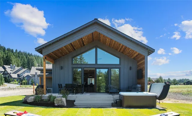 a view of a house with swimming pool and sitting area