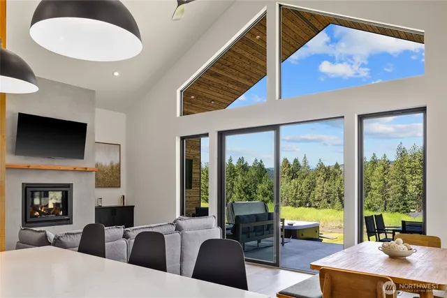 a living room with furniture a flat screen tv and a large window