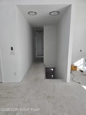 a view of staircase with wooden floor and white walls