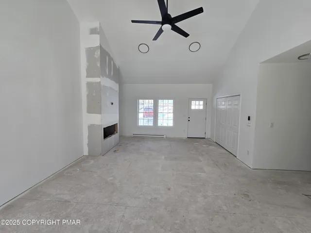 a view of empty room with window and fireplace