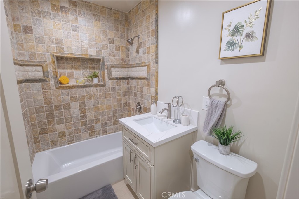 223 South Aprilia Avenue Compton, CA 90220 - Photo 17 of 46 a bathroom with a sink mirror vanity and toilet