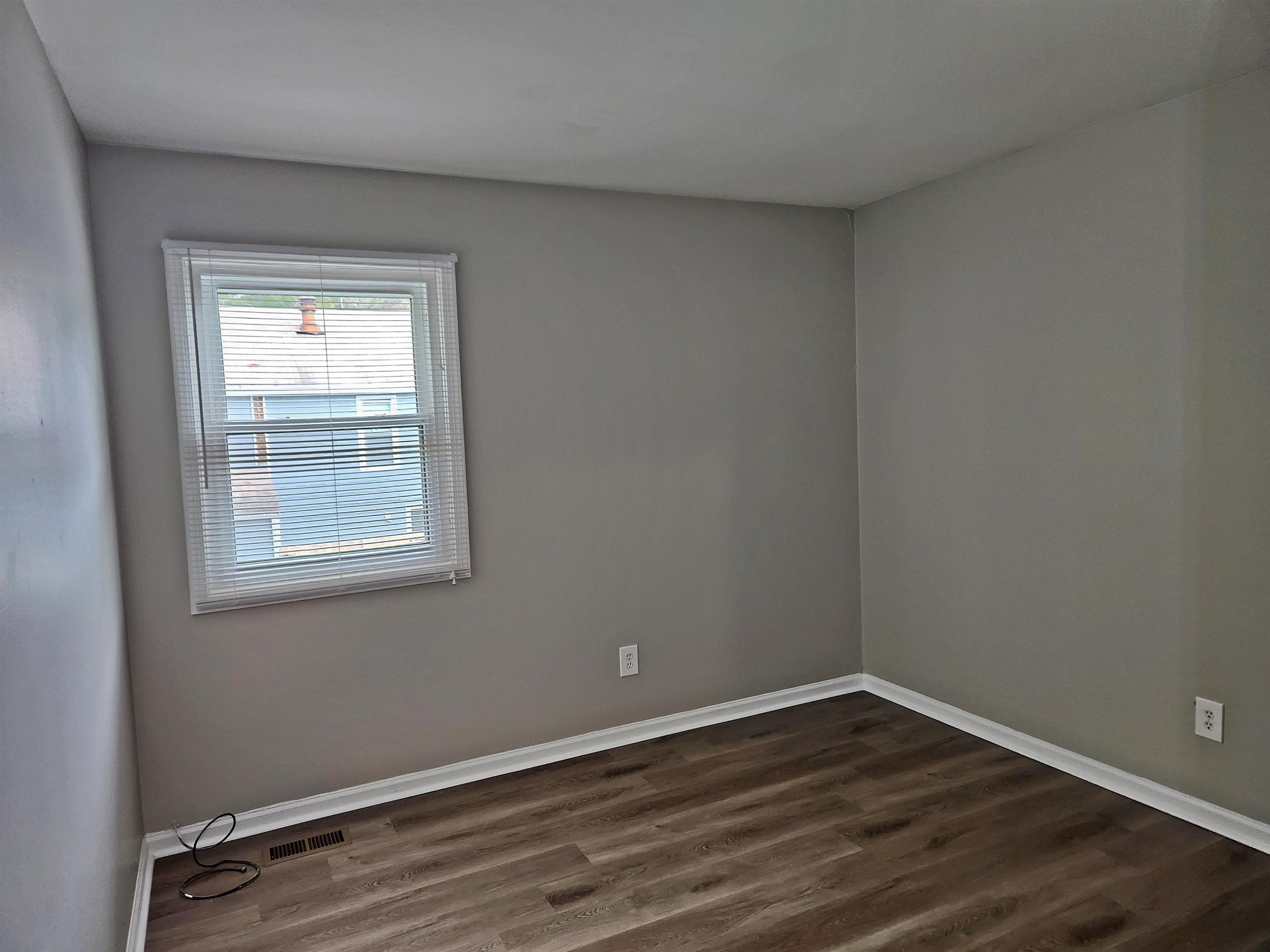 1227 Seaton Road, Unit 66 Durham, NC 27713 - Photo 17 of 29 a view of an empty room with wooden floor and a window