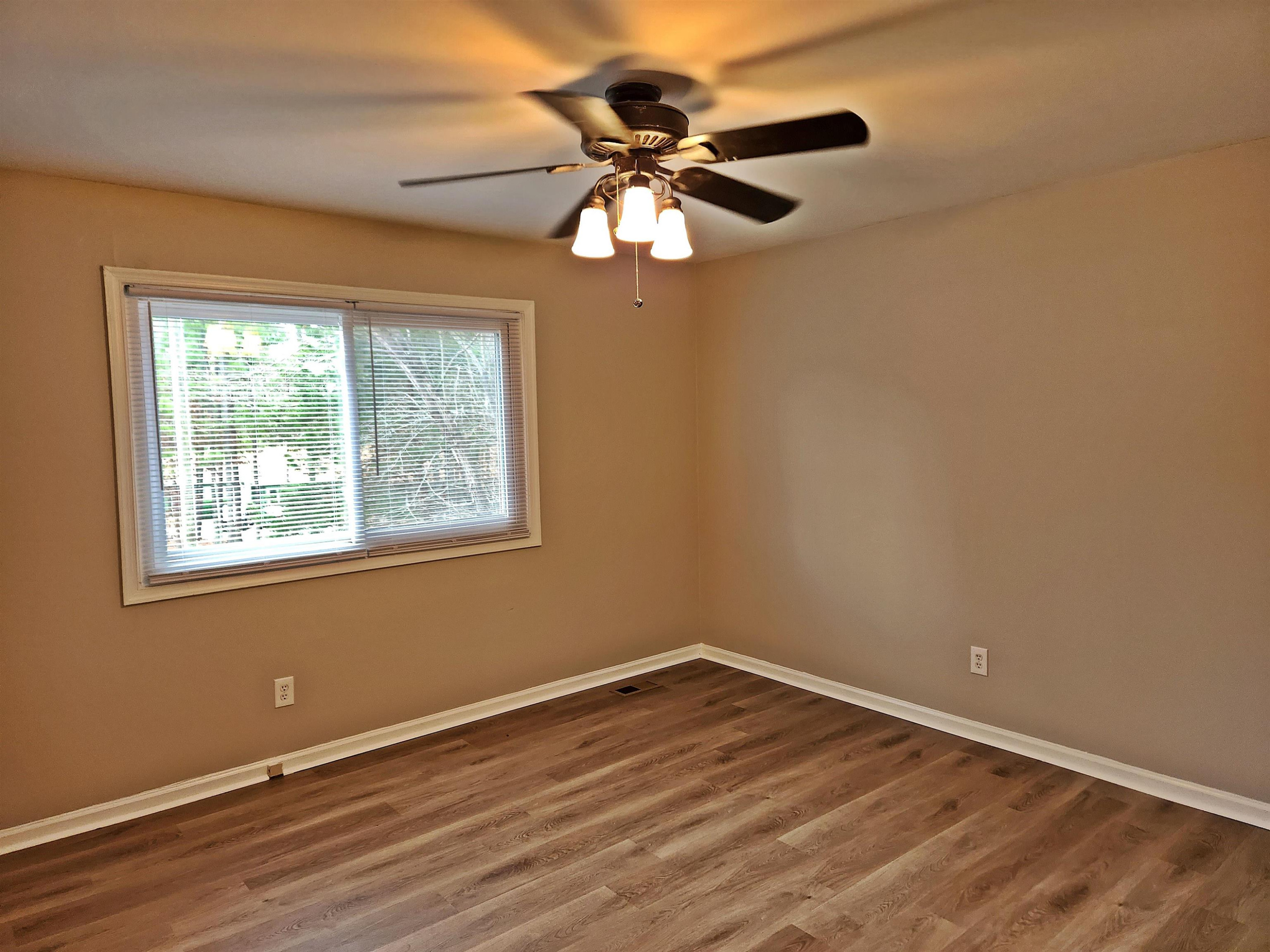 1227 Seaton Road, Unit 66 Durham, NC 27713 - Photo 24 of 29 a view of an empty room with wooden floor and a window
