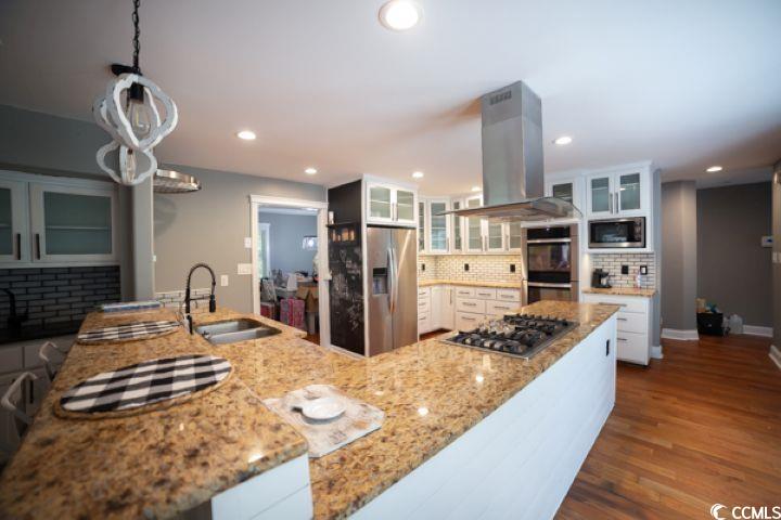 936 Oak Ridge Place Myrtle Beach, SC 29572 - Photo 11 of 36 Kitchen with glass insert cabinets, white cabinetry, dark wood-type flooring, and recessed lighting