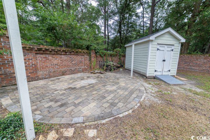 936 Oak Ridge Place Myrtle Beach, SC 29572 - Photo 31 of 36 Fenced backyard with a patio area and a storage shed