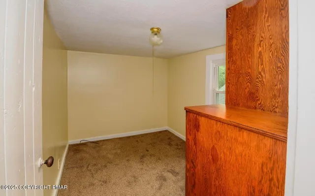 a bathroom with a granite countertop sink a mirror and shower