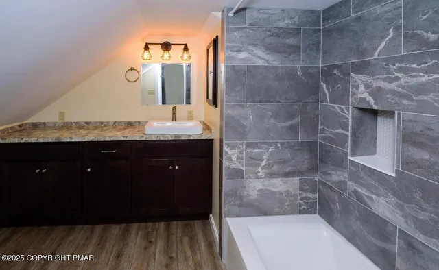 a bathroom with a toilet and bathtub