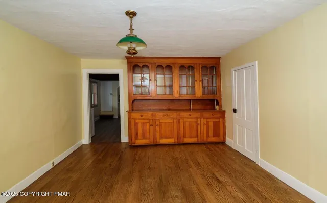 a kitchen with stainless steel appliances granite countertop a stove and a wooden floors