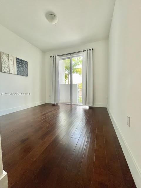 7187 Northwest 103rd Path Doral, FL 33178 - Photo 13 of 20 wooden floor in an empty room with a window