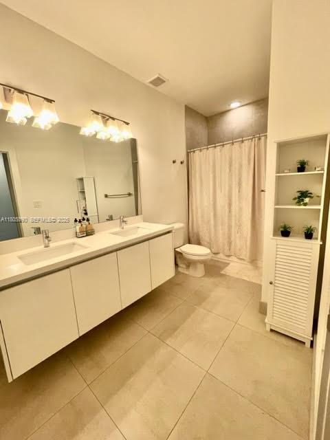 7187 Northwest 103rd Path Doral, FL 33178 - Photo 18 of 20 a bathroom with a double vanity sink a mirror and a bathtub