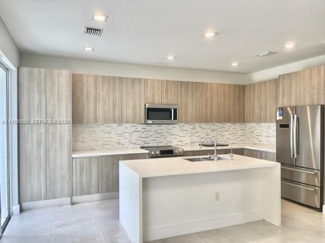 7187 Northwest 103rd Path Doral, FL 33178 - Photo 2 of 20 a kitchen with stainless steel appliances granite countertop a refrigerator and a sink