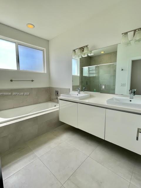 7187 Northwest 103rd Path Doral, FL 33178 - Photo 9 of 20 a bathroom with a bathtub sink and mirror