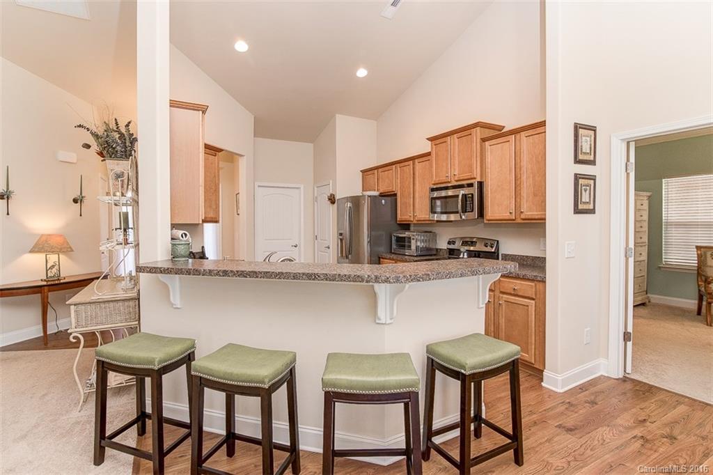 1752 Newland Road Denver, NC 28037 - Photo 2 of 15 a kitchen with stainless steel appliances granite countertop a stove a sink and a refrigerator