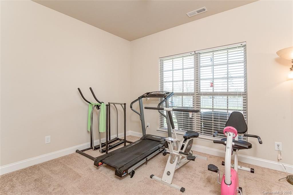 1752 Newland Road Denver, NC 28037 - Photo 11 of 15 a room with gym equipment and windows