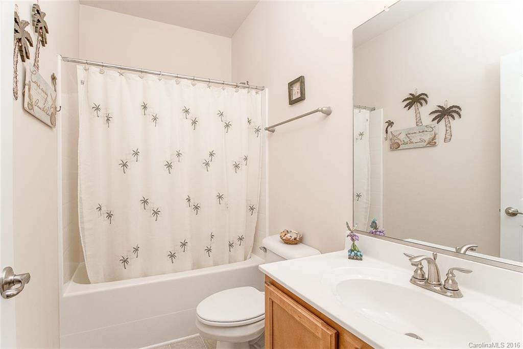 1752 Newland Road Denver, NC 28037 - Photo 12 of 15 a bathroom with a sink a toilet and a large mirror