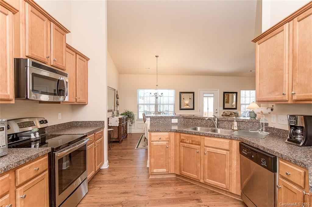 1752 Newland Road Denver, NC 28037 - Photo 3 of 15 a kitchen with stainless steel appliances granite countertop a stove a sink and a microwave