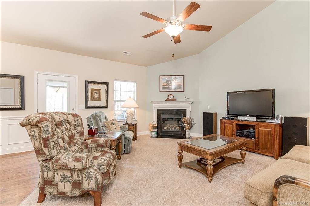 1752 Newland Road Denver, NC 28037 - Photo 5 of 15 a living room with furniture flat screen tv and a fireplace