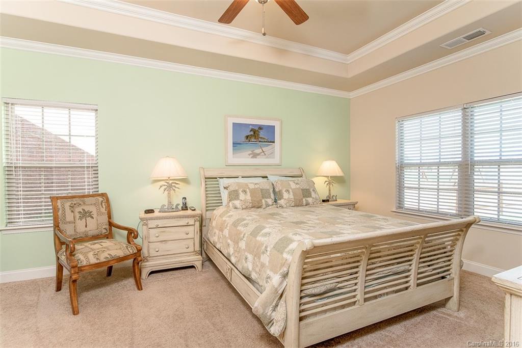 1752 Newland Road Denver, NC 28037 - Photo 6 of 15 a bedroom with a bed and a chandelier