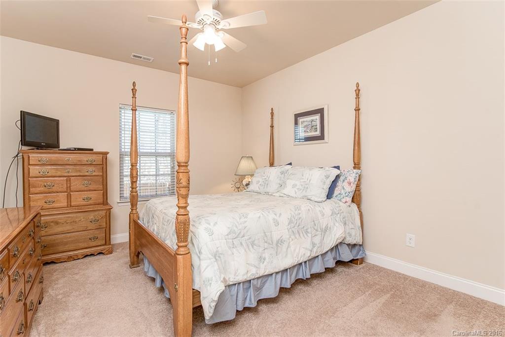 1752 Newland Road Denver, NC 28037 - Photo 9 of 15 a bed room with a bed and a flat tv screen