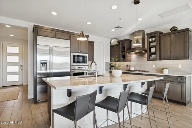 a bedroom with bed and large windows