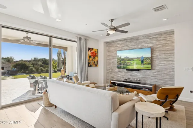 a living room with furniture and a large window with garden view