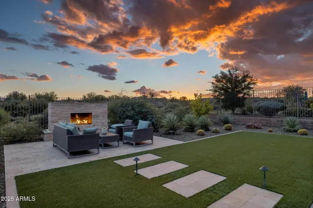 a view of swimming pool with outdoor seating and lake view