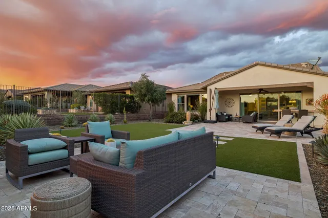 a view of a patio with table and chairs under an umbrella