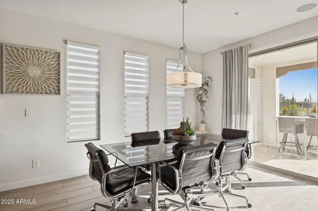 a kitchen with stainless steel appliances granite countertop a kitchen island a table and chairs