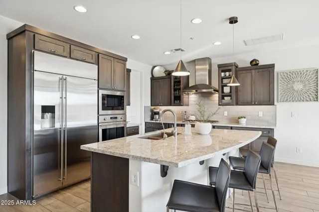 a kitchen with a sink a stove and cabinets