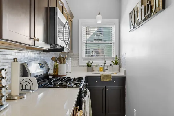 a kitchen with a sink and a stove top oven