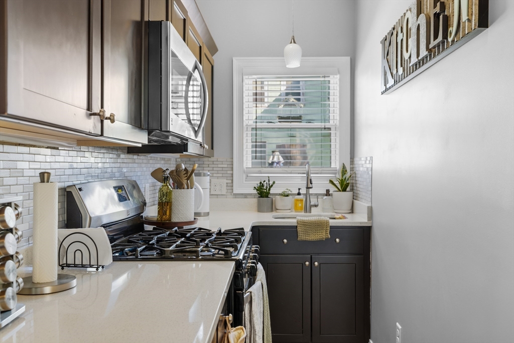 233 Belleville Road New Bedford, MA 02745 - Photo 11 of 40 a kitchen with a sink and a stove top oven