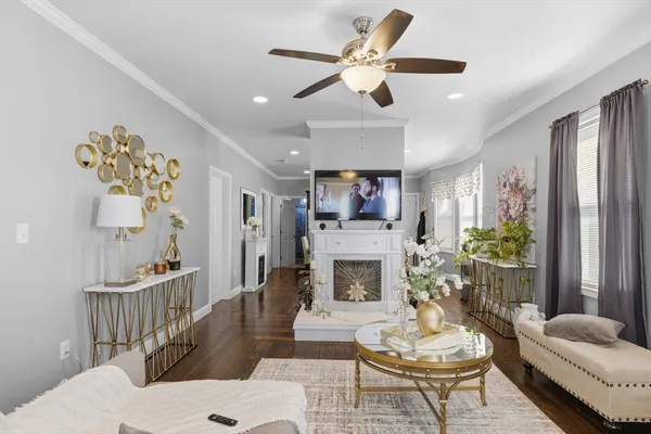 a living room with furniture a fireplace and a flat screen tv