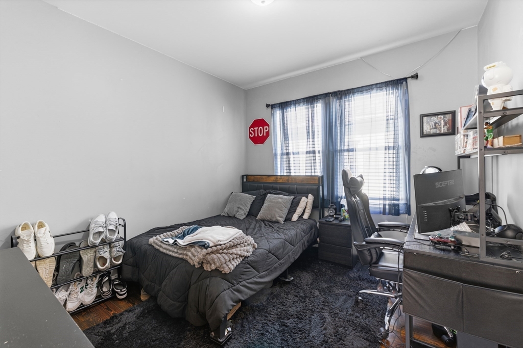 233 Belleville Road New Bedford, MA 02745 - Photo 32 of 40 a bed room with a bed and a chair