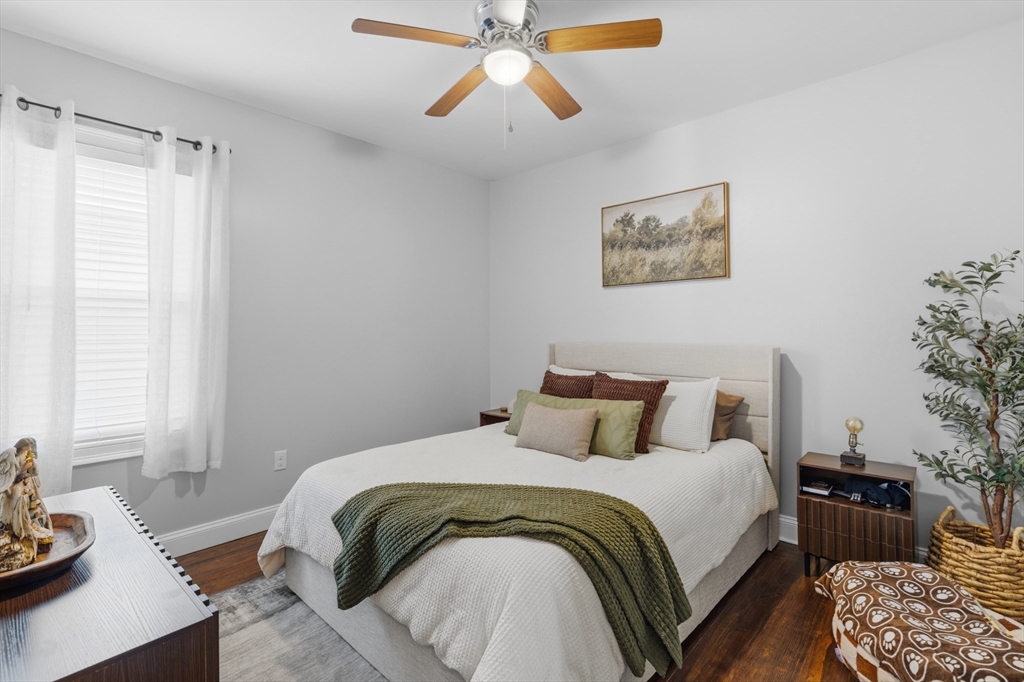 233 Belleville Road New Bedford, MA 02745 - Photo 8 of 40 a bedroom with a bed and a chandelier