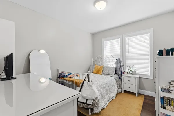 a bedroom with bed and a window