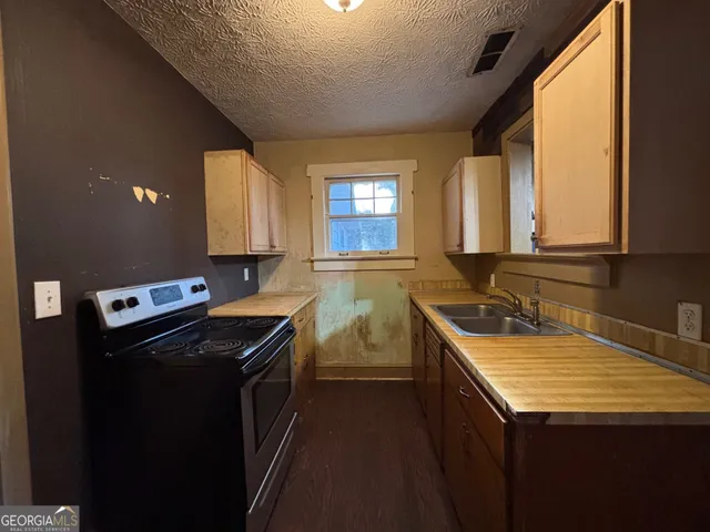 a kitchen that has a sink and a stove