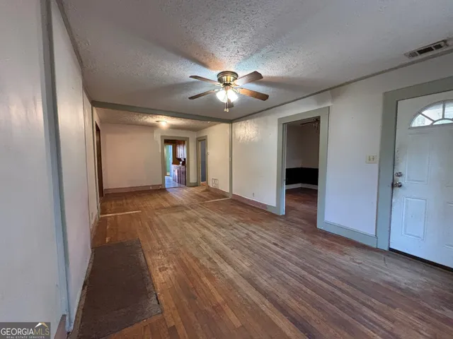 wooden floor in an empty room with a window