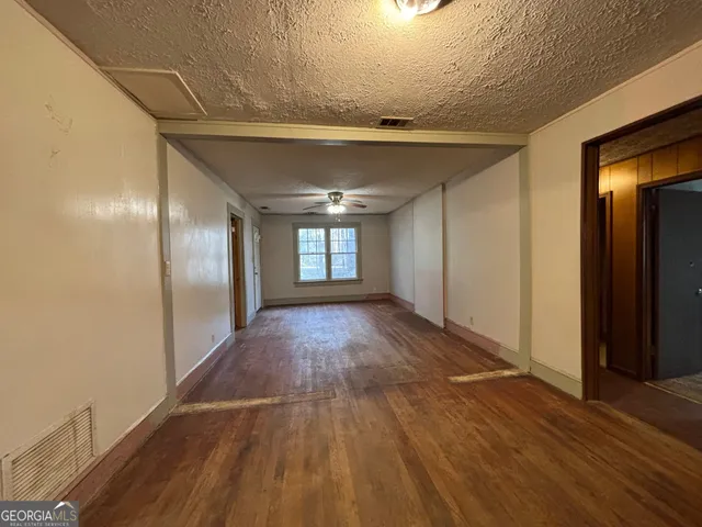 a view of hallway with wooden floor